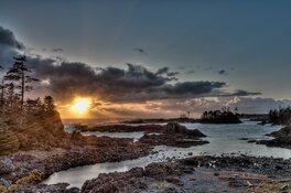 A sunset over a Canadian lake with rocks