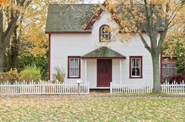 A white and red house in autumn A white and red house in autumn