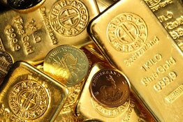 A pile of gold bars and gold coins A pile of gold bars and gold coins